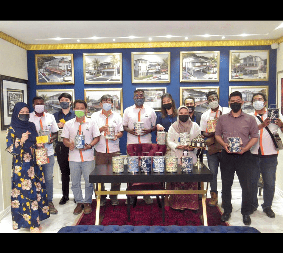 Staff members holding tiffins